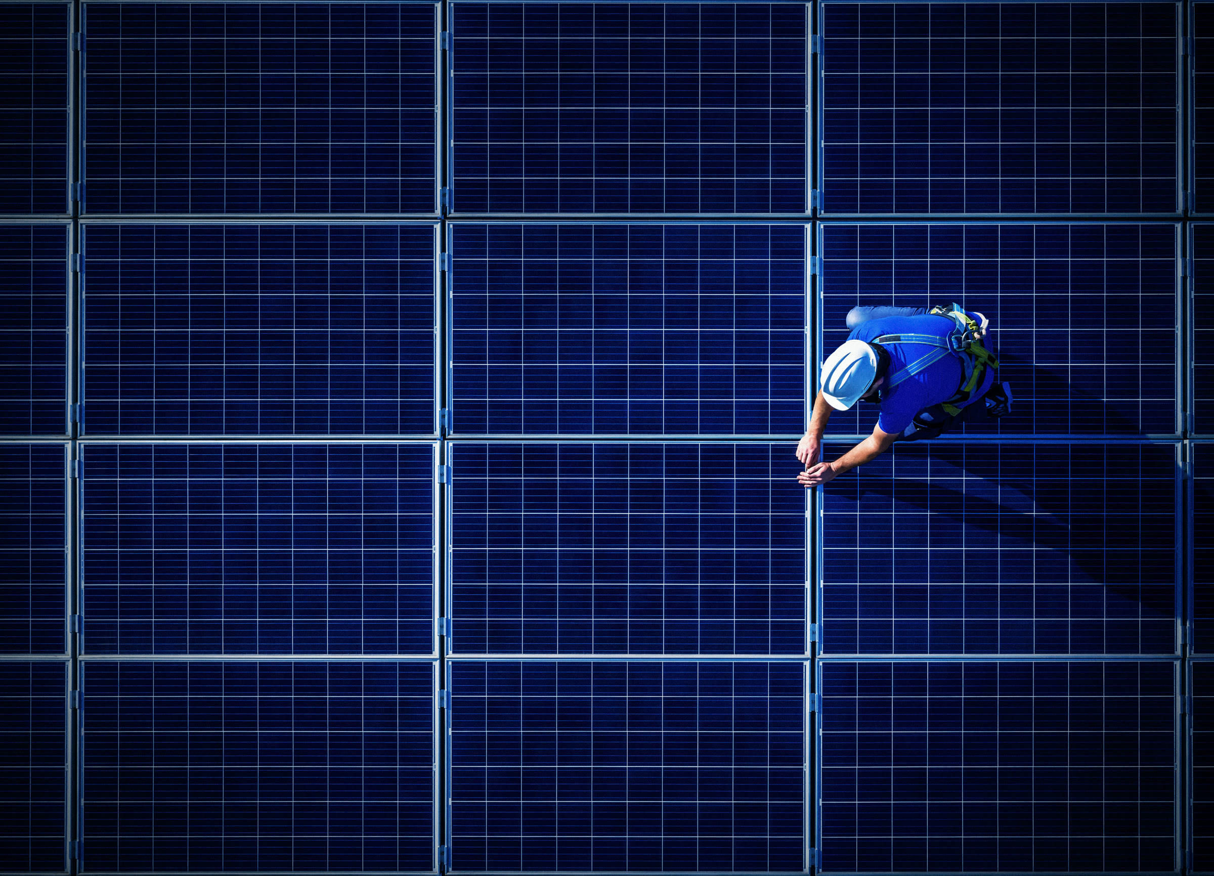 Tecnico Sunprime al lavoro su un campo di moduli fotovoltaici